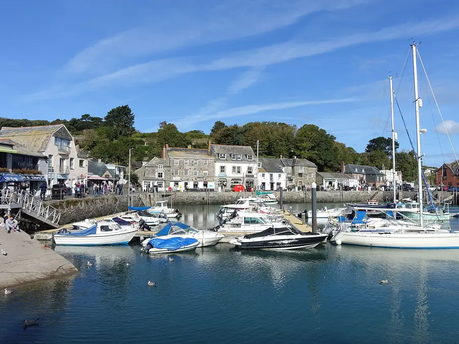 Padstow harbour on the Camel Estuary with moored boats and the town behind